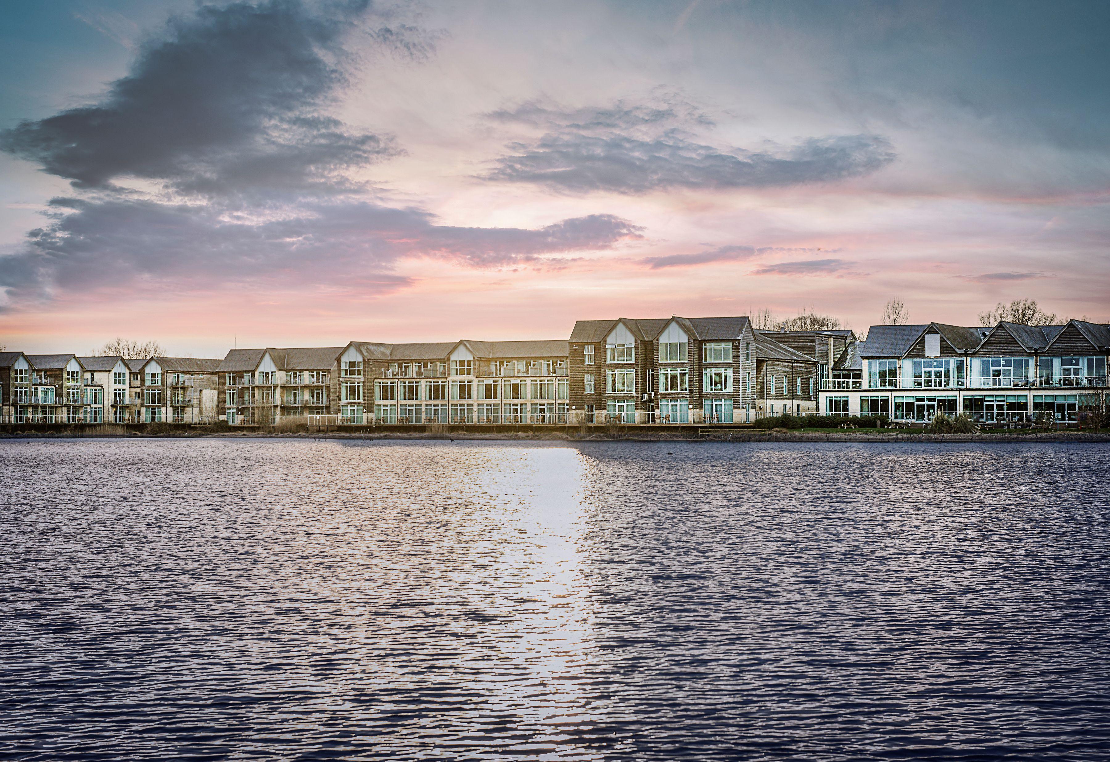 De Vere Cotswold Water Park exterior of building overlooking the lake.